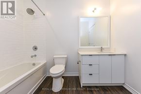 Toronto (Kingsway South) condo for rent - A white bathroom with a toilet, sink, and bathtub.