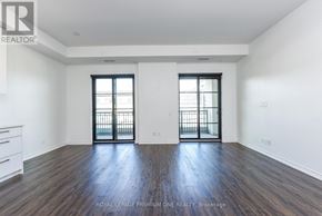 Toronto (Kingsway South) condo for rent - A spacious room with wooden floors and two windows with black frames.