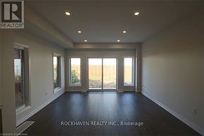 Hamilton (Gibson) townhouse for rent - A spacious room with a view of a wooden fence through the windows.