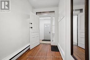 Cambridge multi-family for rent - A hallway with white walls and a wooden floor.