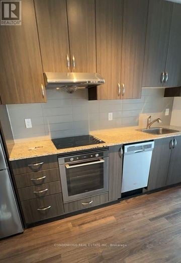 Toronto (Henry Farm) condo for rent - A kitchen with wooden cabinets and a stainless steel dishwasher.