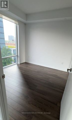 Toronto (Henry Farm) condo for rent - A room with wooden flooring and a large window.