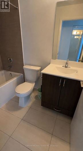 Toronto (Henry Farm) condo for rent - A white toilet sits in a bathroom next to a sink.