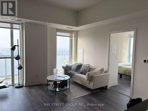 Toronto (Don Valley Village) condo for rent - A living room with a couch, a table, and a view of the water.