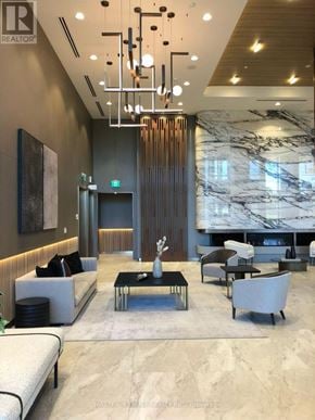 Toronto (York University Heights) condo for rent - A modern living room with a marble floor and a large chandelier.