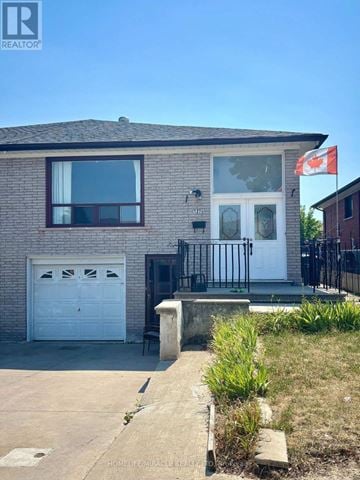 Mississauga (Malton) apartment for rent - A house with a Canadian flag on the front.
