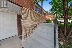Bradford West Gwillimbury (Bradford) apartment for rent - A house with a white garage door and a brick wall.