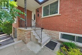 Bradford West Gwillimbury (Bradford) apartment for rent - A red brick house with a white window and a black metal railing.