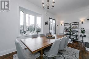 Toronto (Woodbine Corridor) apartment for rent - A dining room with a wooden table and chairs.