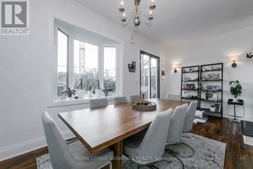 Toronto (Woodbine Corridor) apartment for rent - A dining room with a wooden table and chairs.