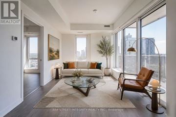 Toronto (Regent Park) condo for rent - A living room with a couch, a chair, a coffee table, and a painting on the wall.