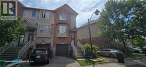 Kitchener townhouse for rent - A two-story residential building with a car parked in front.