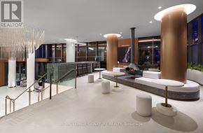 Toronto (Kensington-Chinatown) condo for rent - A modern lobby with a glass wall and a reception desk.