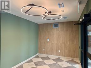 Thorold (Thorold Downtown) apartment for rent - A spacious room with a kitchen area and a view of the outdoors through a sliding glass door.