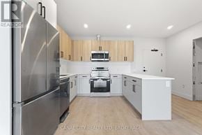 Thorold (Thorold Downtown) apartment for rent - A modern kitchen with wooden cabinets and stainless steel appliances.
