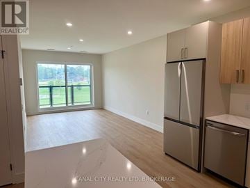 Thorold (Thorold Downtown) apartment for rent - A modern kitchen with wooden cabinets and stainless steel appliances.