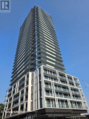 Toronto (Bayview Village) condo for rent - A tall building with a blue sky in the background.