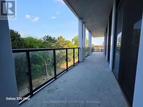 Toronto (Bayview Village) condo for rent - A balcony with a view of trees and a fence.