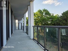 Toronto (Bayview Village) condo for rent - A balcony with a view of trees and sky.
