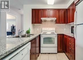 Toronto (Woburn) condo for rent - A kitchen with white appliances and brown cabinets.