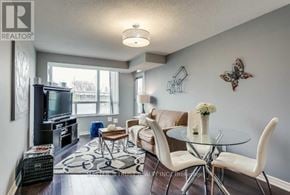 Toronto (Woburn) condo for rent - A living room with a glass table and white chairs.