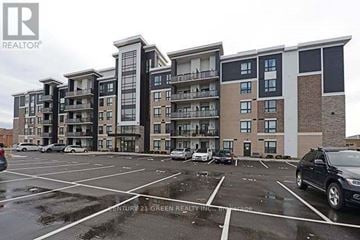 Milton (Be Beaty) condo for rent - A parking lot in front of a multi-story apartment building.