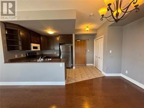 Sudbury apartment for rent - A kitchen with dark wood cabinets and a white countertop.