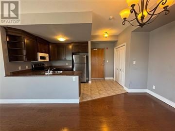 Sudbury apartment for rent - A kitchen with dark wood cabinets and a white countertop.