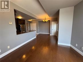 Sudbury apartment for rent - A well-lit, empty living room with wooden floors and white walls.