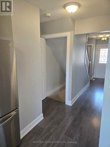 London North (North C) townhouse for rent - A kitchen with a stainless steel refrigerator and wooden flooring.