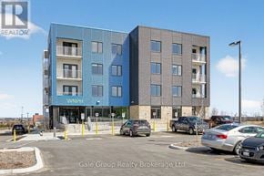 Woodstock (Woodstock - South) apartment for rent - A modern two-story building with a blue and gray facade and a parking lot in front.