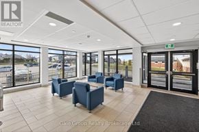 Woodstock (Woodstock - South) apartment for rent - A waiting area with blue chairs and a view of a parking lot through the windows.
