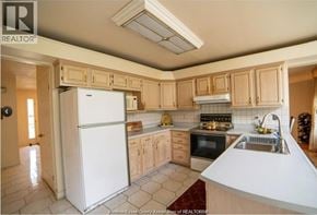 Windsor apartment for rent - A kitchen with a white refrigerator and wooden cabinets.