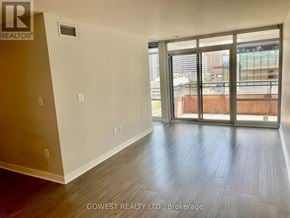 Toronto (Waterfront Communities) condo for rent - A room with a sliding glass door leading to a balcony.