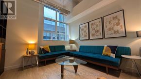 Toronto (Church-Yonge Corridor) condo for rent - A living room with a blue couch and a coffee table.