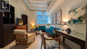 Toronto (Church-Yonge Corridor) condo for rent - A living room with a sofa, armchair, and a bed.