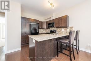 Ottawa townhouse for rent - A kitchen with a bar stool and a counter.