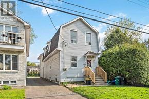 Ottawa apartment for rent - A two-story house with a grey exterior and a red door.