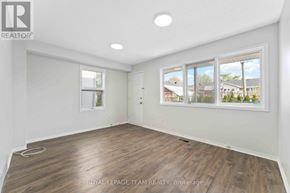 Ottawa apartment for rent - A room with a large window and wooden flooring.