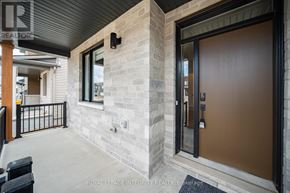 Ottawa apartment for rent - A modern house entrance with a glass door and a stone wall.