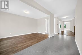 Ottawa apartment for rent - A spacious room with wooden flooring and white walls.