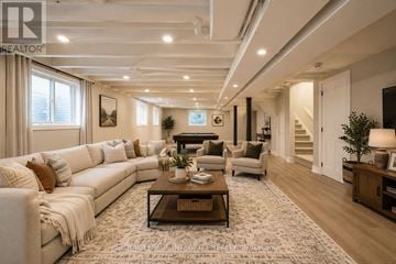 Ottawa apartment for rent - A spacious living room with a white sofa set and a coffee table.
