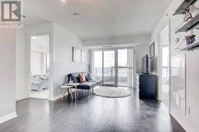 Toronto (Henry Farm) condo for rent - A living room with a couch, a chair, and a small table.
