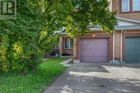 Ottawa townhouse for rent - A house with a purple garage door is for sale.