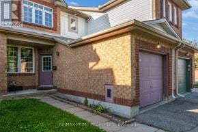 Ottawa townhouse for rent - A house with a purple door is for sale.