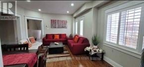 Brampton (Fletcher's Meadow) apartment for rent - A living room with a red couch and a coffee table.
