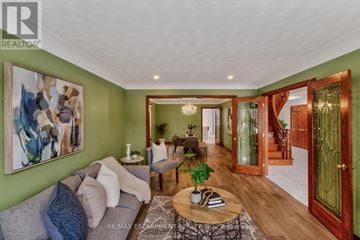 Hamilton (Stoney Creek) apartment for rent - A living room with a grey couch and a painting on the wall.