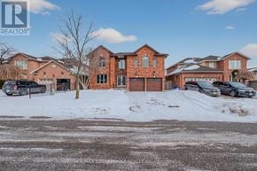 Hamilton (Stoney Creek) apartment for rent - A large red brick house with a snow-covered front yard.