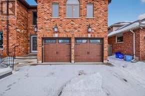 Hamilton (Stoney Creek) apartment for rent - A red brick house with a brown garage door.