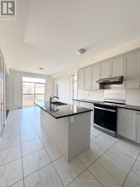 East Gwillimbury (Holland Landing) apartment for rent - A kitchen with white cabinets and a black countertop.